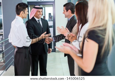 translator introducing arabian businessman to business partners