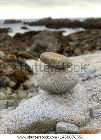Stacking rocks on the beach.