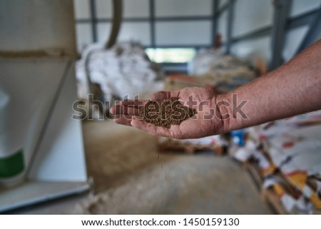 compound feed in a man's hand