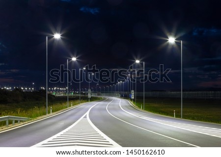 night empty road with modern LED street lights Royalty-Free Stock Photo #1450162610