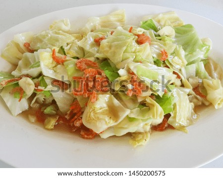 Stir fried cabbage in fish sauce with dried shrimp Served on white plate Royalty-Free Stock Photo #1450200575