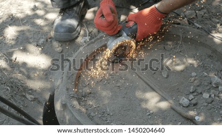 Man works circular saw. Flies of spark from hot metal.