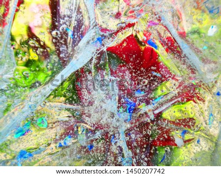 Garbled red flowers through the liquid with bubbles. Focus on bubbles