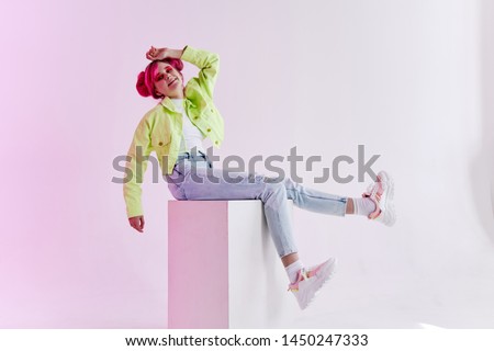 woman with hairstyle sitting on a cube of nineties fashion style