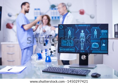 Advanced human body research displayed monitor in laborator. Researchers in human health.