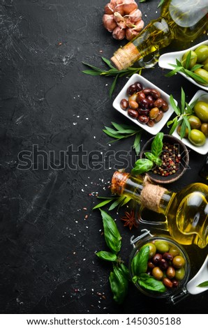 Olives, olive oil, spices and herbs on the Rustic background. Top view. Free space for your text.