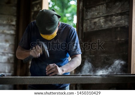 carpenter using Hammer while working on a piece of wood. Thai Carpenter, Carpentry, Working, Wood - Material
