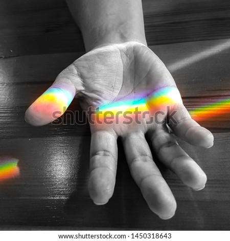 Rainbow over hand reaching out 
