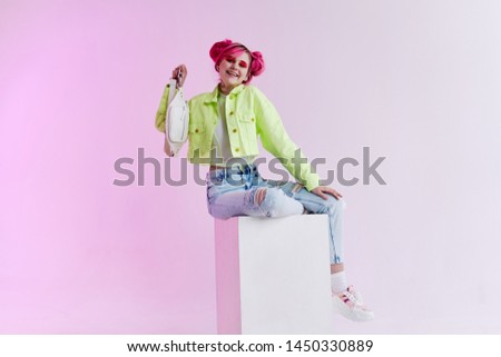 woman in a green jacket with pink hair