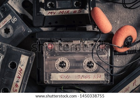 Vintage audio cassette with headphones and red walkman Royalty-Free Stock Photo #1450338755