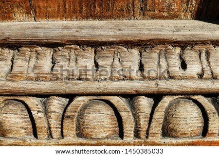 Old wooden carvings on a wooden board.