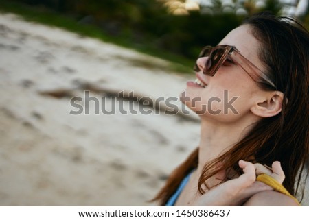 woman with glasses resting on the beach                               