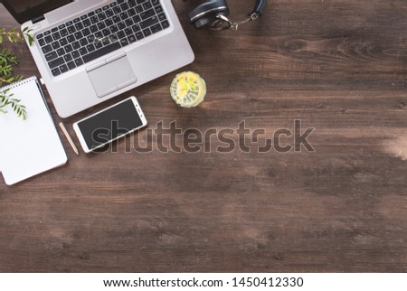 Top view of hipster wooden workspace, office table desk, flat lay image of two coworkers using laptop and discussing at office workspace, mock-up of blank screen of laptop computer and mobile phone