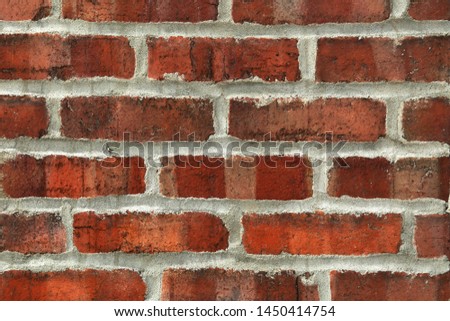 Mat brick wall in natural terra cotta colour with light grey cement