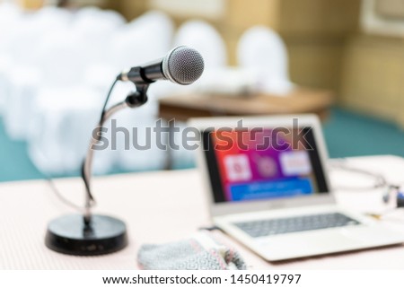 Wired microphone set up on the front of conference room close up with blurred background.  Wired microphone close up with copy space background. Royalty-Free Stock Photo #1450419797