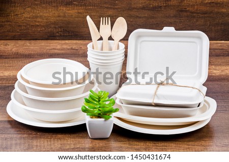 Set of unbleached plant fiber food box and paper coffee cup. Natural fiber eco food and drink packaging. Royalty-Free Stock Photo #1450431674