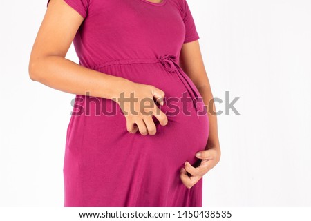 Pregnancy scratching belly on white background Royalty-Free Stock Photo #1450438535