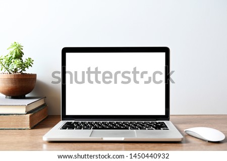 Laptop computer with blank screen in office