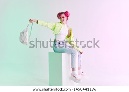 woman with pink hair with a bag on a cube fashion