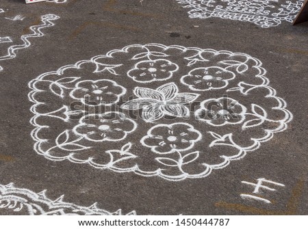 Indian traditional kolam (known in tamil language) or rangoli is drawn using white colored rice, during festival season 3021 chennai india tamil nadu mylapore