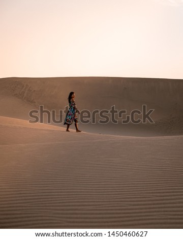 young woman at the dessert of Maspalomas sand dunes Gran Canaria during vacation at the Canary Islands