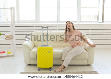 Holidays, travel, and vacations concept - young woman is going to the trip