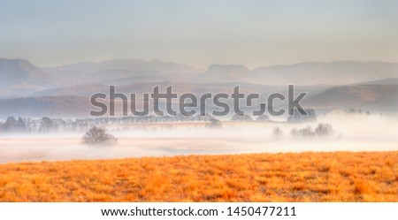 FOGGY WINTER MORNING view across farmlands in the Umzimkulu Valley, Underberg, Kwazulu Natal, South Africa