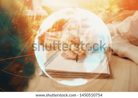 International business hologram over woman's hands taking notes background. Concept of success. Double exposure
