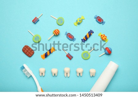 Teeth with sweet candies. Tooth caries in children's, dental healthcare, toothpaste and toothbrush.