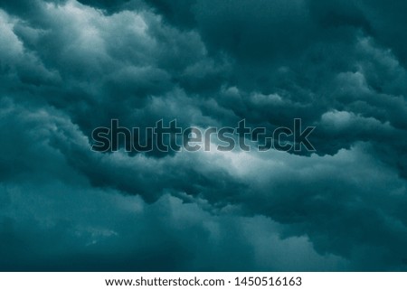 Dark sky during overcast rainy weather. Photo in deep blue tones. 