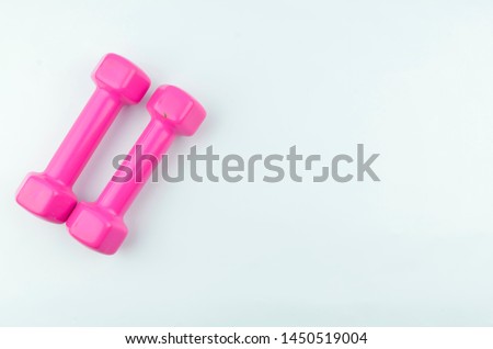 Two pink dumbbells isolated on white background.