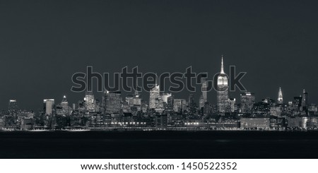 New York City midtown skyline with skyscrapers over Hudson River viewed from New Jersey at night