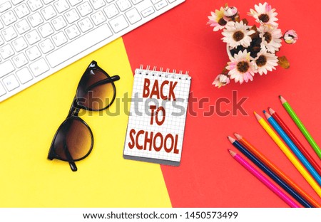 back to school translated in french concept,  notebook isolated on colorful paper background