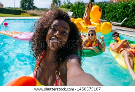 group of friends having fun in the swimming pool