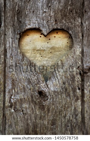 Heart hole an an old weathered wooden door