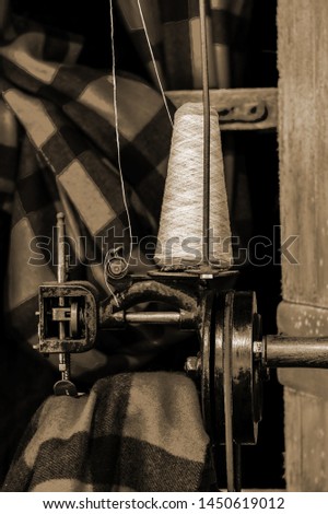 Old 1900s Woolen Mill Machinery and Sewing Yarn into Fabric in sepia tone