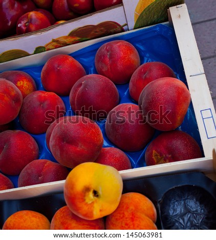 peaches and apricots in the boxes, tropical fruit