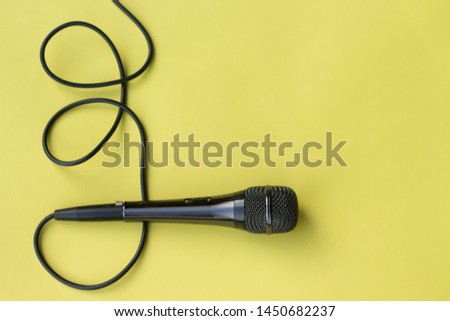 microphone for blogger, journalist or musician work on yellow background. karaoke microphone. top view mock up top view space for text