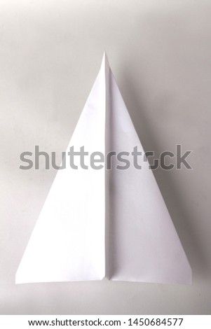 White paper plane on white background 
