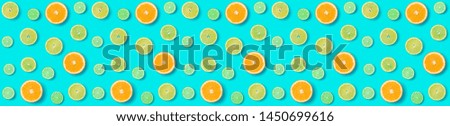 Creative layout made of colorful tropical fruits isolated on blue background. Minimal summer exotic concept. Citrus fruit seamless pattern.  Аlat lay, top view. Orange, Lime, Lemon slices background. 