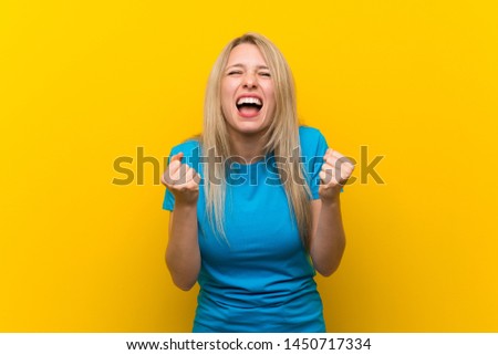 Young blonde woman over isolated yellow background frustrated by a bad situation