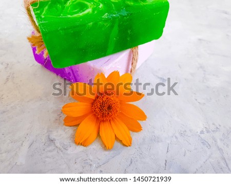 cosmetic soap flower calendula on a gray concrete background
