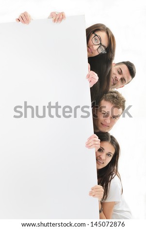 Two happy boys and two happy girls isolated on white leaning behind a blank banner