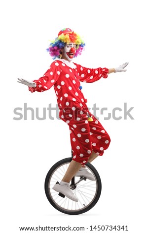 Full length shot of a cheerful clown riding a unicycle isolated on white background