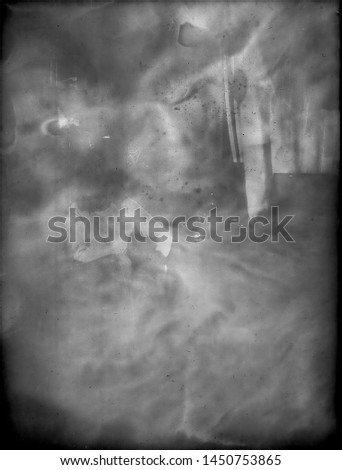 A real, black and white large-format spoiled photo with dust and scratches. Glass photographic plate with scratches, dust, dirt, out of focus image.