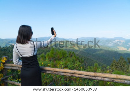 Asian woman  selfie travel in holiday. Background mountain and forest in winter season.