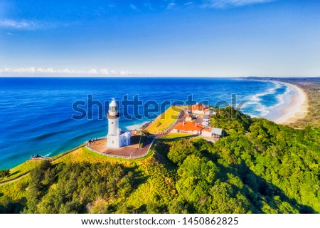 The top of headlands at Byron Bay with famous white lighthouse of the most eastern point of Australian continent overlooking Pacific ocean and wide sandy beaches. Royalty-Free Stock Photo #1450862825