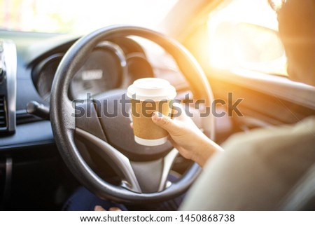 Hand holding hot coffee take away cup on car , Abstract Blur picture
