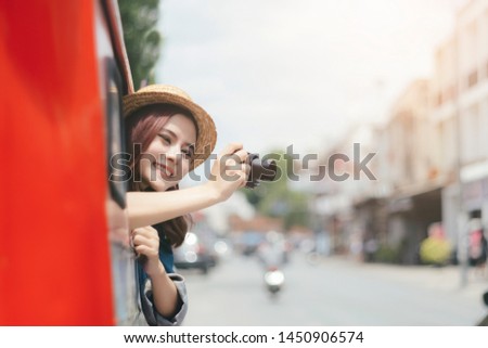 Excited tourists are taking pictures while sitting on the car. Tour and city travel in summer.