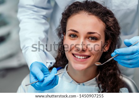 Health check. Dentist in stomatology center is making an examination of girl teeth by using dental tools. Royalty-Free Stock Photo #1450907255